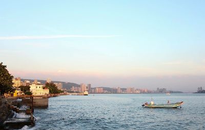 Nautical vessel on river against sky in city