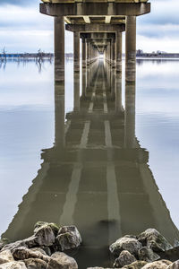 View of pier over river against sky