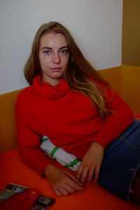 Portrait of a young woman sitting at home