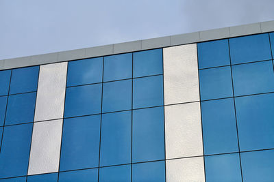 Modern glass office building with blue sky background. bank financial office building wall