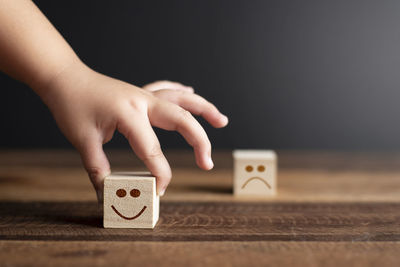 Close-up of hands playing piano on table