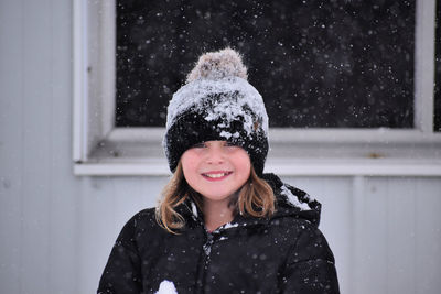 Portrait of smiling young woman standing outdoors