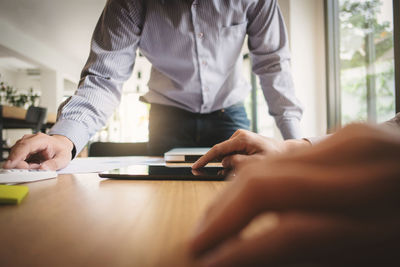 Midsection of man working at table