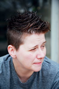 Close-up portrait of lesbian with furrowed eyebrows and cool hair