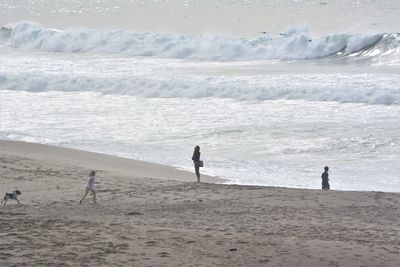 Mother enjoying with children at beach