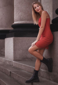 Full length of woman standing on steps