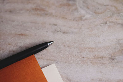 Close-up of pen with diary on table