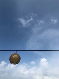 Low angle view of light bulb against sky