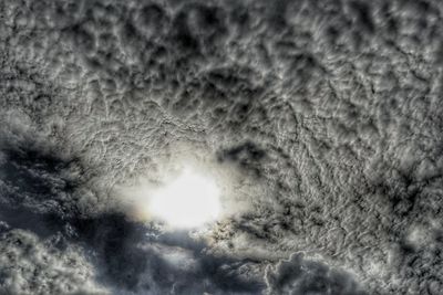 Low angle view of sun shining in sky