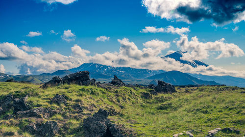 Scenic view of mountains against cloudy sky