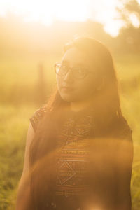 Portrait of young woman standing outdoors