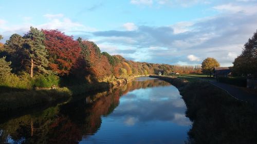 Bridge over river against sky during autumn