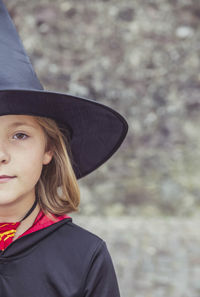 Young fair-haired sorceress in mantle and hat