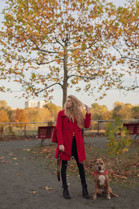 Full length of man with dog standing at park