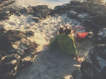 Rear view of woman on rock at beach