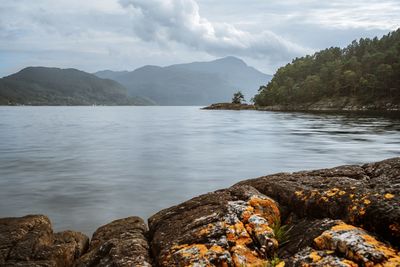 Scenic view of lake and mountains against sky