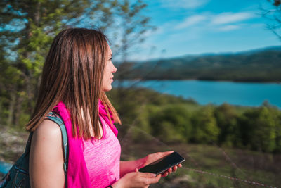 Midsection of woman using mobile phone