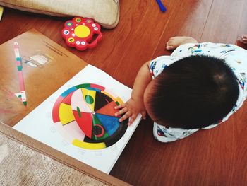 High angle view of boy playing on table at home