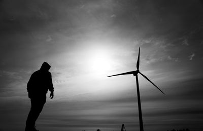 Silhouette man standing against sky during sunset