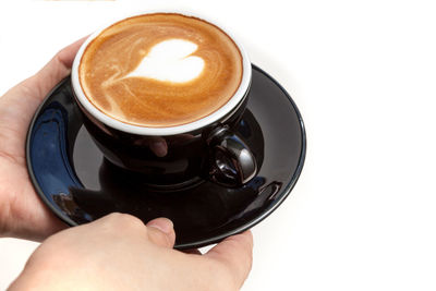 Close-up of hand holding coffee cup