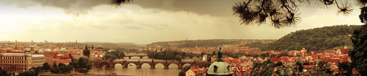 Panoramic view of city against cloudy sky