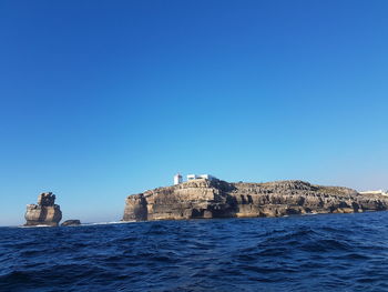 Scenic view of sea against clear blue sky