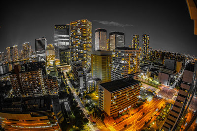 High angle view of illuminated buildings in city at night