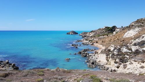 Scenic view of sea against clear blue sky