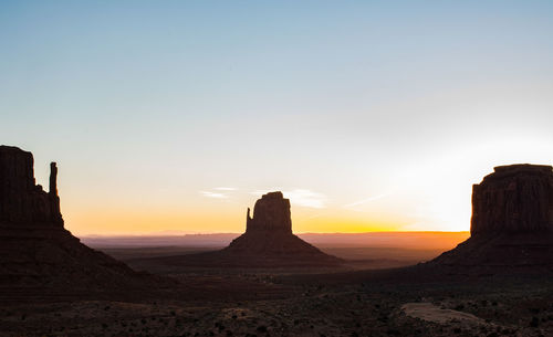 Scenic view of rock formations against sky during sunset