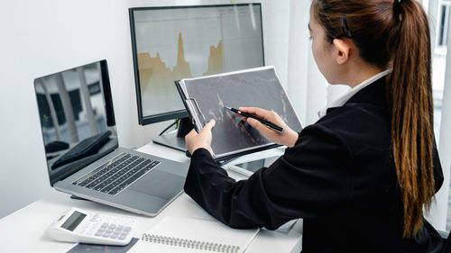 Businesswoman using laptop at office