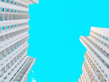 Low angle view of buildings against clear blue sky