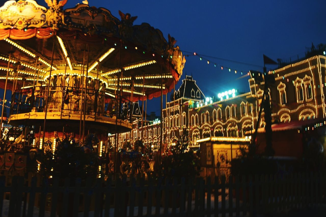 illuminated, amusement park ride, amusement park, night, sky, dusk, multi colored, arts culture and entertainment, built structure, outdoors, ferris wheel, carousel, no people