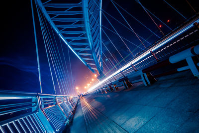 Low angle view of illuminated bridge at night