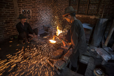 People sitting by fire