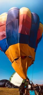 Low angle view of hot air balloon against clear blue sky