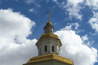 Orthodox church iagainst the blue clouds sky. outdoors, building fasade side view.