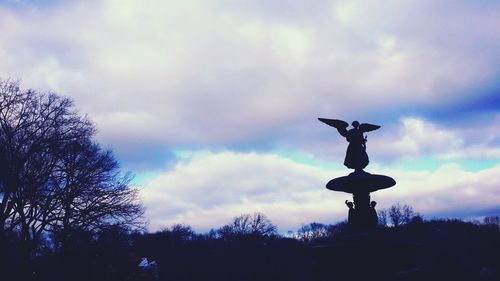 Low angle view of statue against cloudy sky