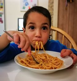 Portrait of boy eating food