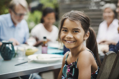 Portrait of a smiling young woman on table