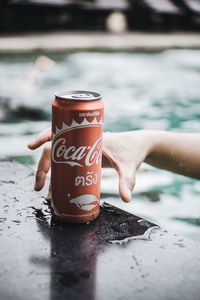 Midsection of woman with drink in water