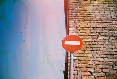 Close-up of road sign on wall