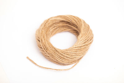 Close-up of rope over white background