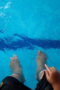 High angle view of man standing in swimming pool