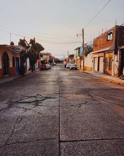 Road in city against clear sky