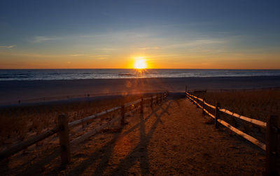 Scenic view of beach against sky during sunset