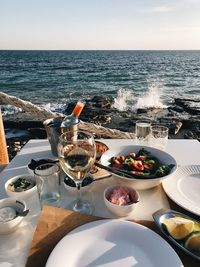 High angle view of food on table by sea against sky