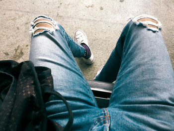 Low section of man wearing shoes