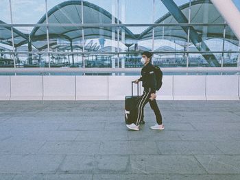 Man with umbrella walking on airport