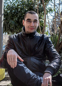 Portrait of young man sitting outdoors