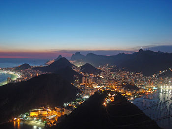 High angle view of city lit up at night